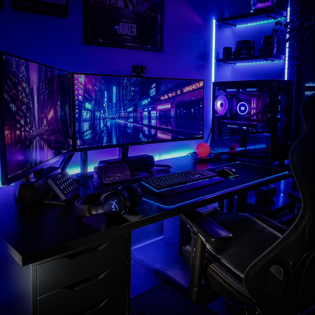 Gaming setup with multiple monitors, RGB lighting, and headphones during a late-night session