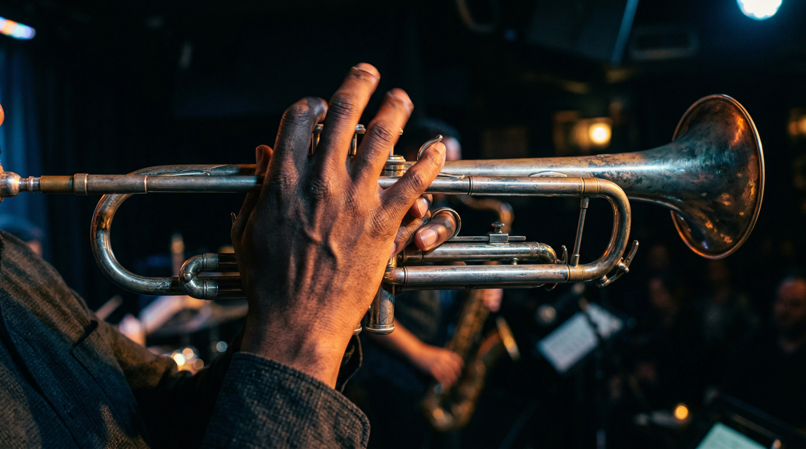 Close-up of a jazz trumpeter's hand fingering valves during an intense bebop performance under stage lighting