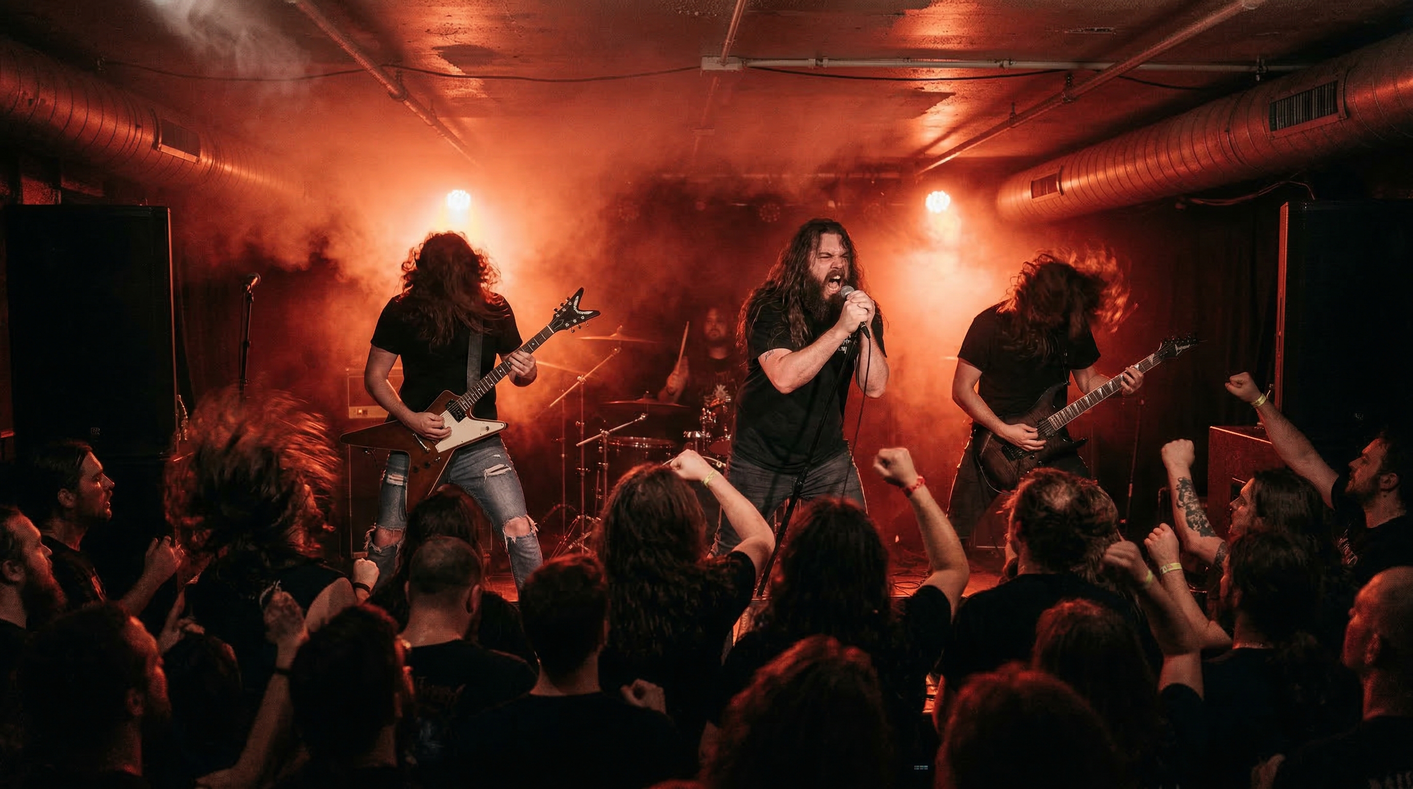 Dark underground venue with intense red lighting and extreme death metal performance