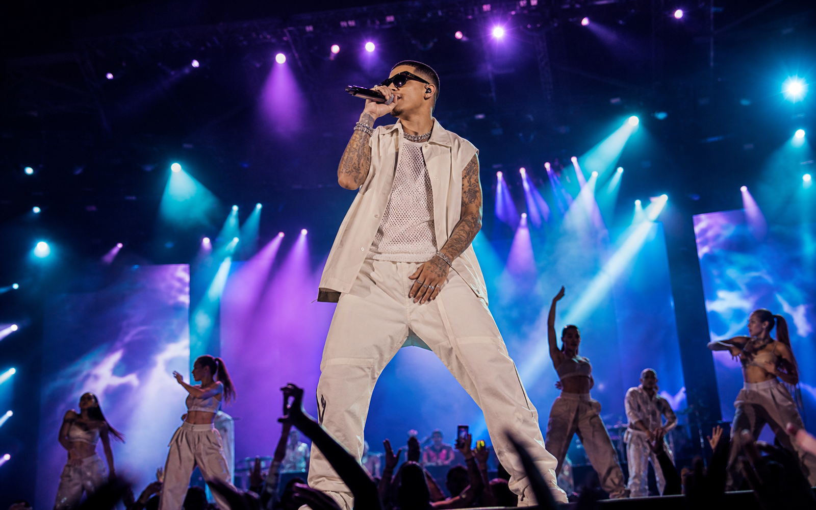 Reggaeton pop star performing at a festival main stage
